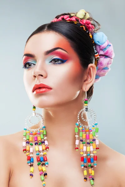 Brunette girl in colourful earrings — Stock Photo, Image