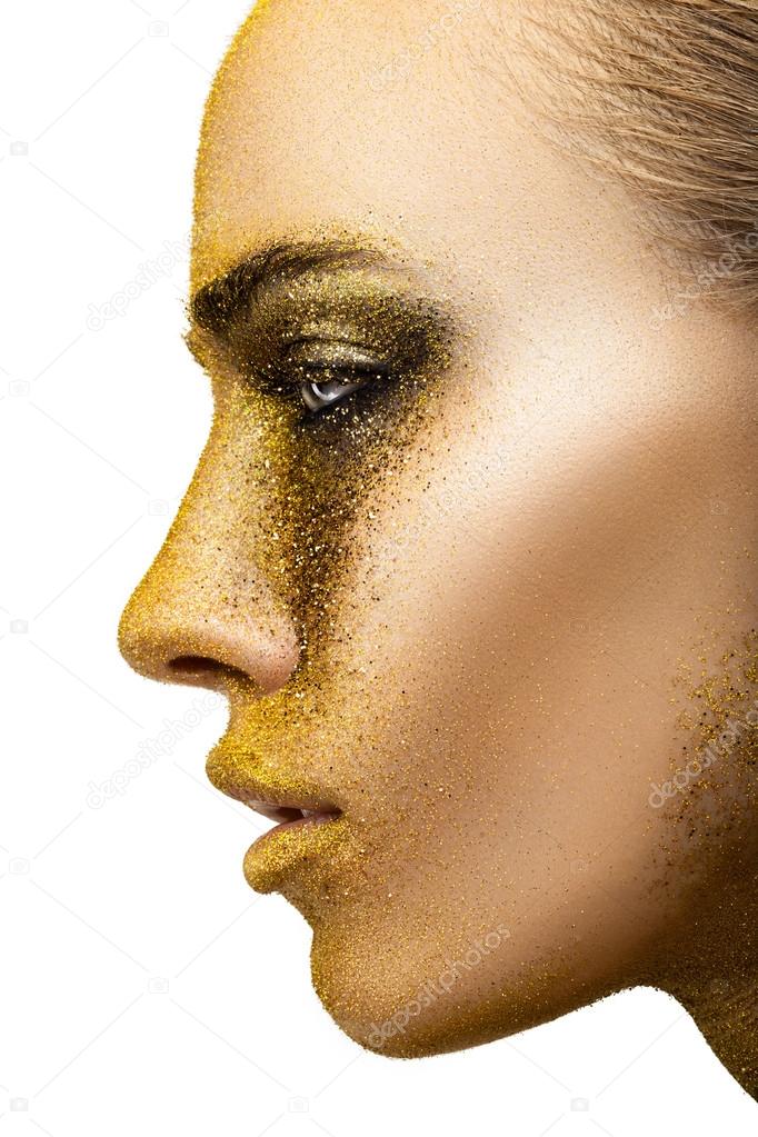 Woman with golden creative make-up