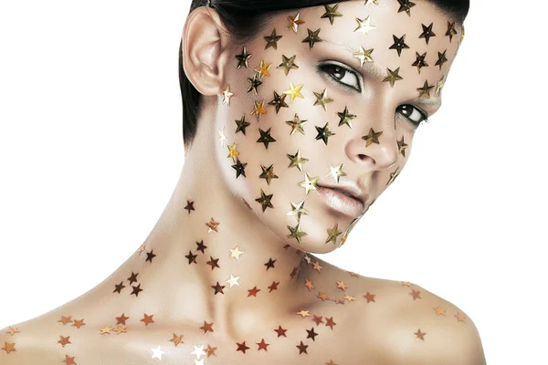 Mulher com estrelas de ouro rosto — Fotografia de Stock