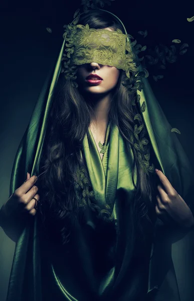 Geheimnisvolle Frau in grünen Blättern — Stockfoto
