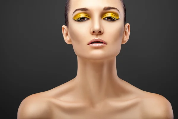 Woman with yellow eyeshadows — Stock Photo, Image