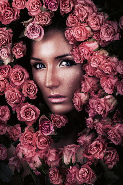 Portrait of woman face in many roses