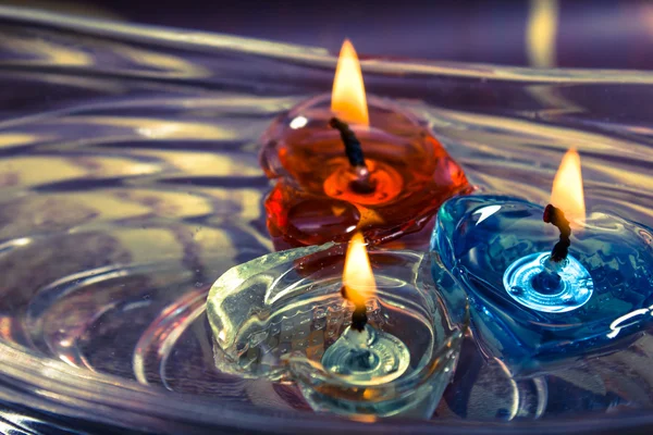 Colorful three candles floating on water aroma bowl,retro — Stock Photo, Image