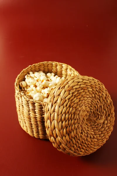 Popcorn on red background with basket — Stock Photo, Image