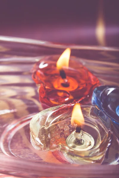 Floating burning candles in glass bowl - retro effect — Stock Photo, Image