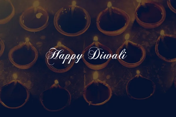 Celebrating happy diwali poster with oil lamps, retro effect — Stock Photo, Image