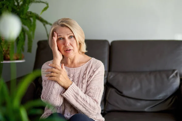 Vrouw lijden aan een hoofdpijn en stress houden haar handen aan haar slapen — Stockfoto