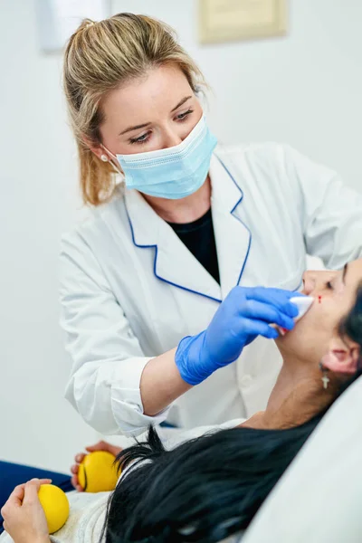 Cosmetic injection in the spa salon. Beautician makes injection into the patients face. Beauty injections, mesotherapy, revitalization, cosmetic medicine injection