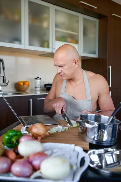 Man cooking with help of recipe on tablet. — Stock Photo, Image