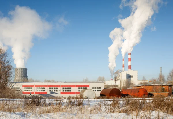 Industrial park with chimney and white smoke on blue sky — Stock Photo, Image