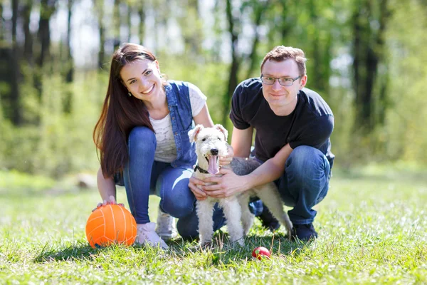Feliz jovem casal e cão — Fotografia de Stock