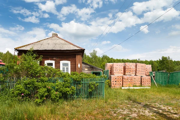 Bricks near old village house — Stock Photo, Image