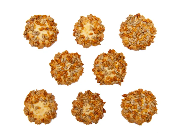 Sušenky s ořechy a slunečnicová semínka, izolované na bílém — Stock fotografie