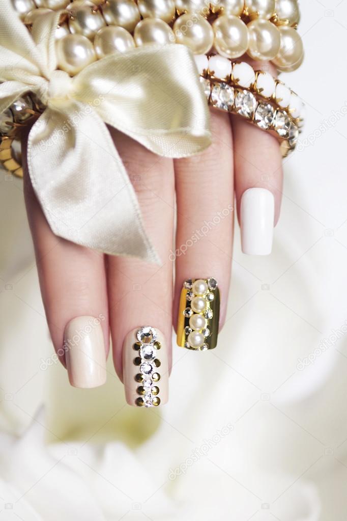 Pearl manicure with rhinestones.