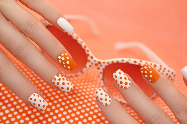Sunny orange manicure with dots . — Stock Photo, Image