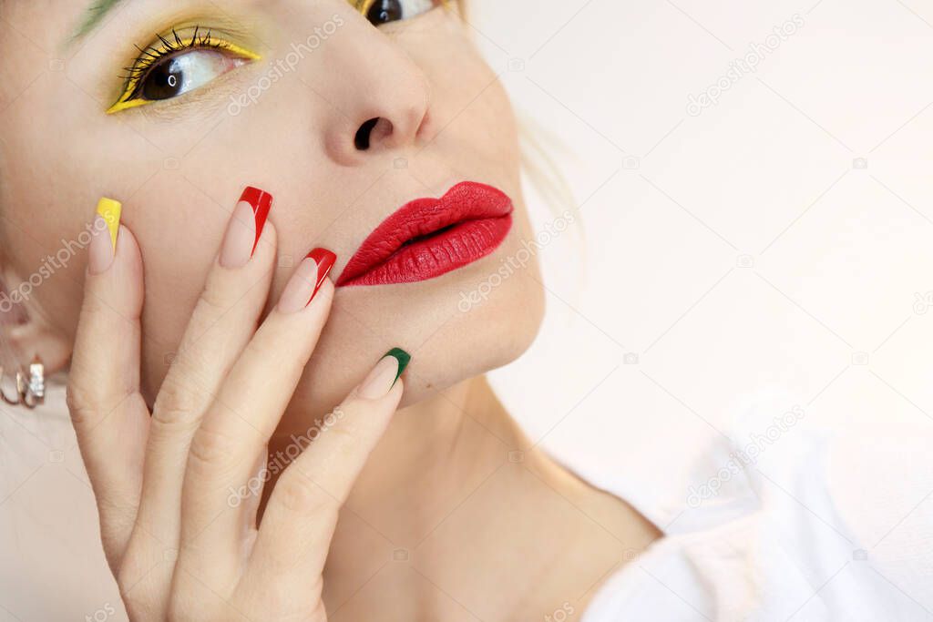 Model with multicolored makeup and French manicure.