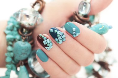 Manicure with stones of turquoise.