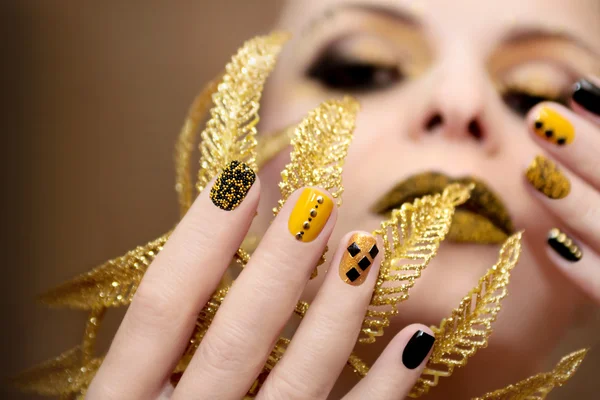 Yellow black manicure.