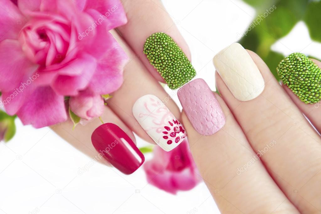 Multicolored manicure with flower.