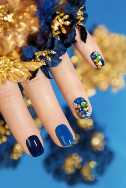 Blue and gold manicure. clipart