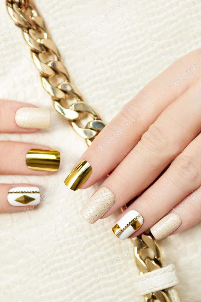 Gold manicure with rhinestones.