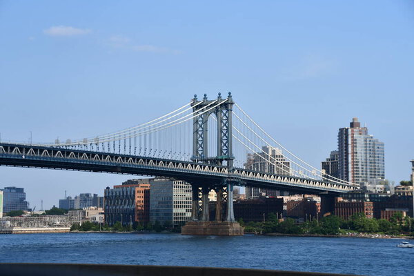 NEW YORK, NY - JUN 20: Manhattan Bridge in New York City, seen on June 20, 2021. is a suspension bridge that crosses the East River in New York City, connecting Lower Manhattan with Downtown Brooklyn.