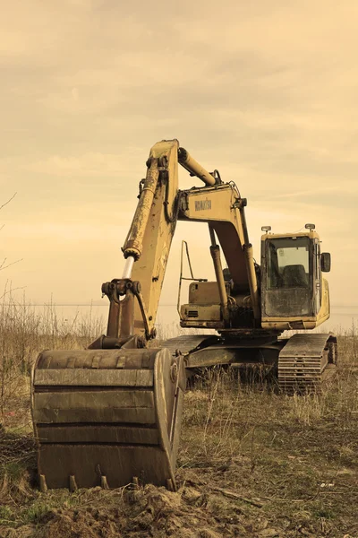 Excavator on the sea shore — Stock Photo, Image