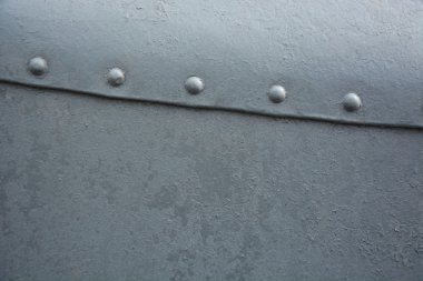 Grey metal background with rivets