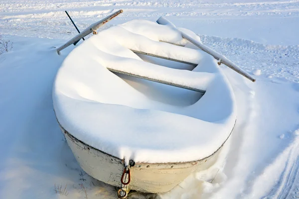 Лодка под снегом зимой — стоковое фото