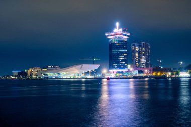 Modern buildings on the shores of the bay in Amsterdam at night clipart