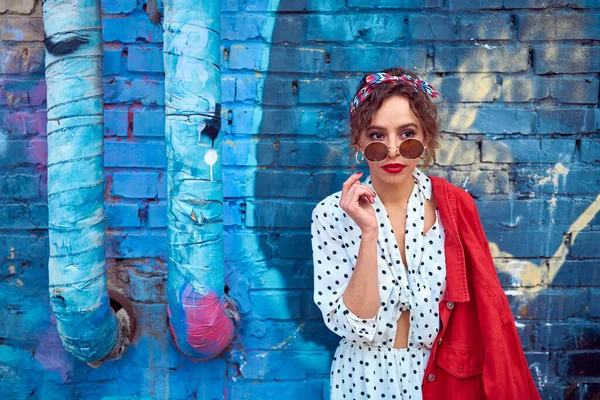 Pensive Girl Sunglasses White Polka Dot Dress Blue Brick Wall — Stock Photo, Image