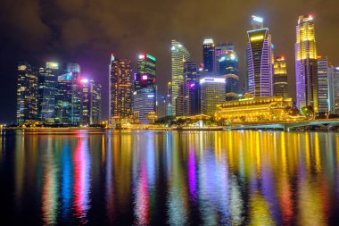 View of the central business district with modern skyscrapers at night in Singapore