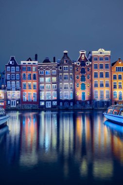 Old brick dancing houses near the canal in Amsterdam at night