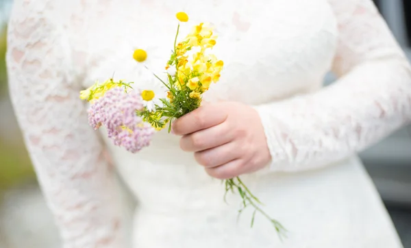 Beautiful wedding bouquet in hands of the bride Royalty Free Stock Photos