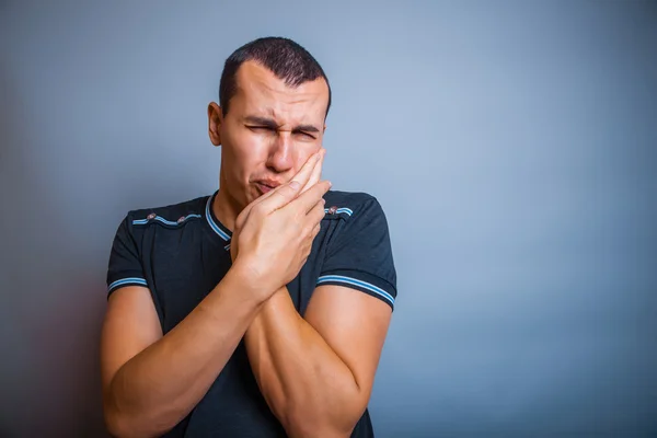 Years old man of European appearance suffers a toothache on — Stock Photo, Image