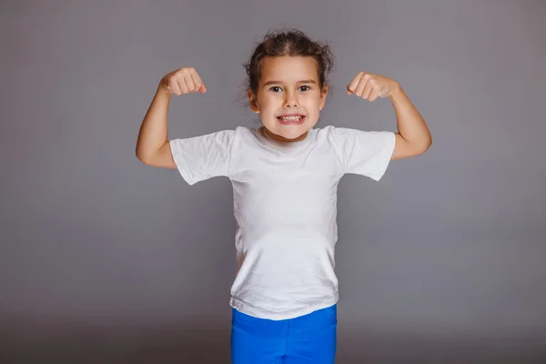 Girl child strong hands on a gray background — Stock Photo, Image