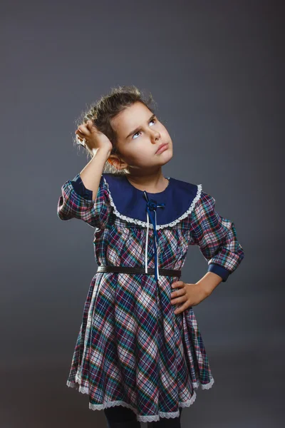 Girl in a colorful dress looking up and wondering — Stock Photo, Image