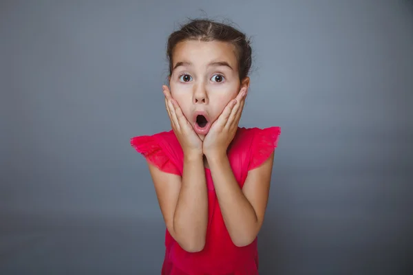 Girl on gray background in a red dress covered her face — Stock Photo, Image