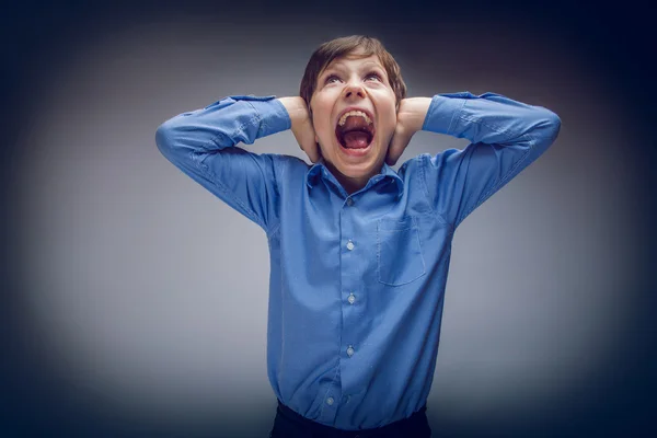 Boy teenager of European appearance brown hair closed his ears s — Stock Photo, Image