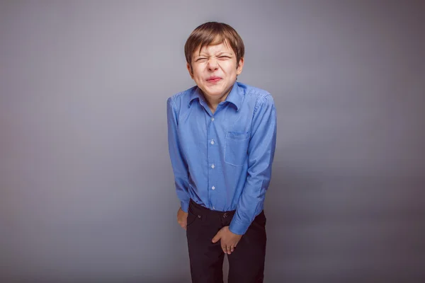 Boy teenager European appearance winced his hand on groin — Stock Photo, Image