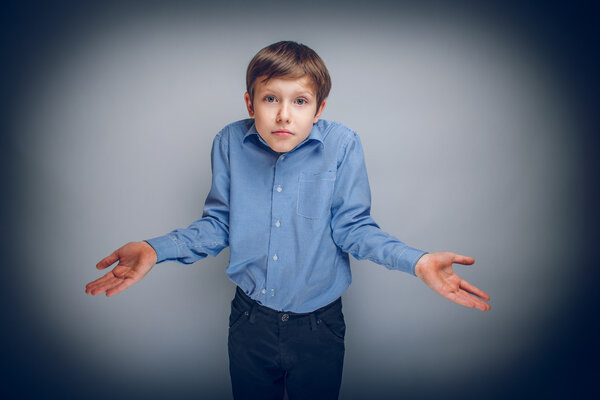 boy teenager of European appearance brown hair threw up his hand