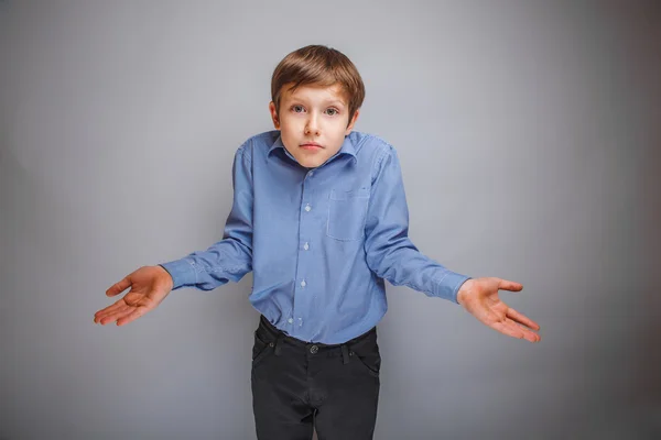 Boy teenager of European appearance brown hair threw up his hand — Stock Photo, Image