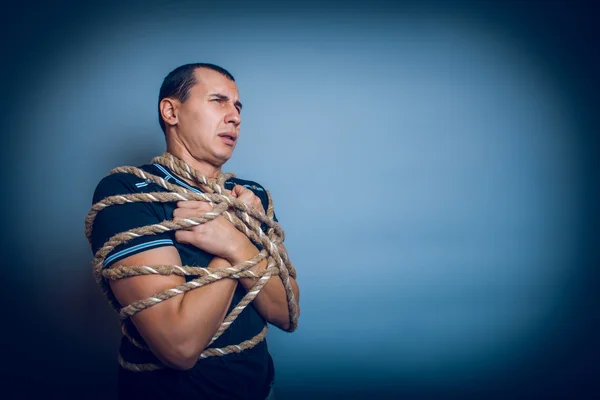 Male of European appearance brunet tied with a rope around the b — Stock Photo, Image