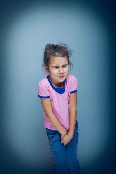 Tiener meisje wil gebruiken het toilet op een grijze achtergrond cross pro — Stockfoto