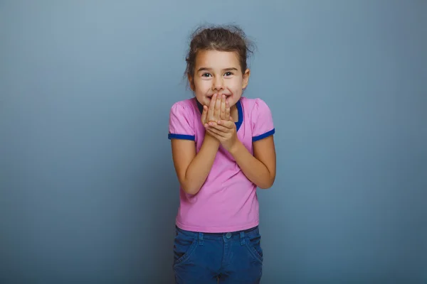 Baby girl oops hand to mouth on gray background — Stock Photo, Image