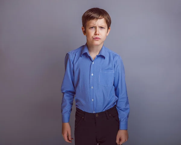 Teenager boy of 10 years European appearance portrait on gray — Stock Photo, Image