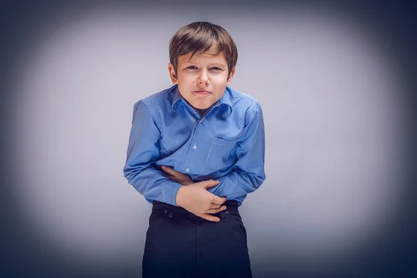 Teenager boy 10 years of European appearance stomach ache, ga — Stock Photo, Image