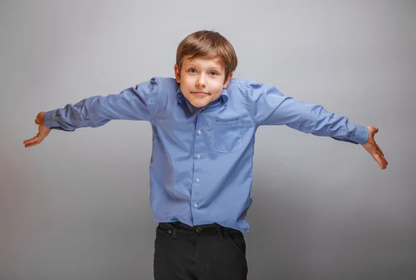 Teenager boy 10 years of European appearance spread his hands — Stock Photo, Image