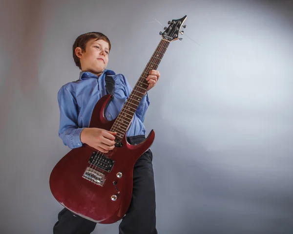 Teenager boy 10 years worth of European appearance playing gu — Stock Photo, Image