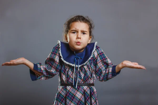 Baby girl spread her hands on a gray background — Stock Photo, Image